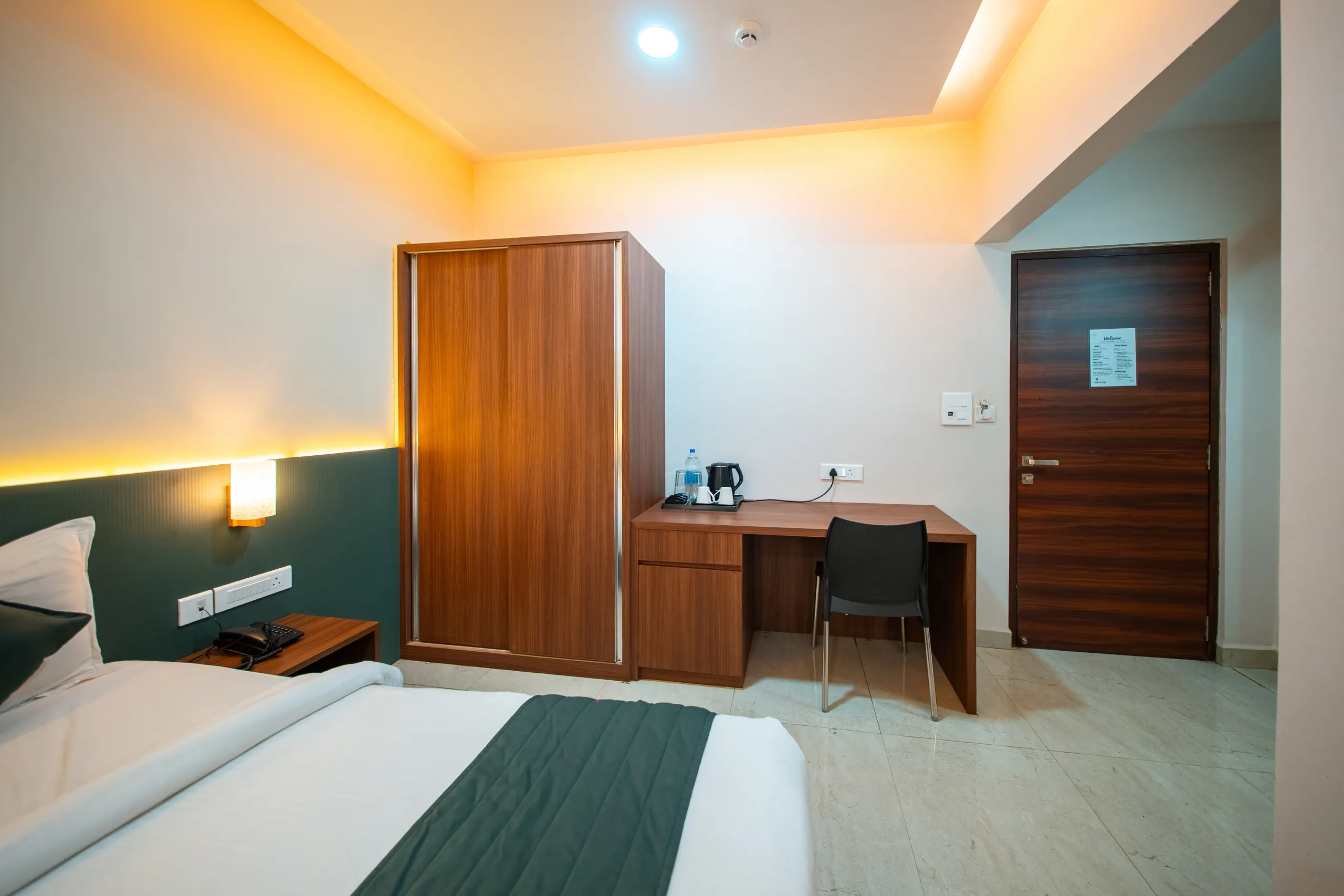 An Executive Twin room showing the wardrobe, desk and kettle station
